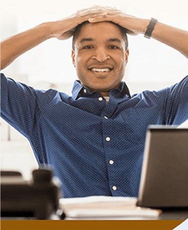 man with hands behind head