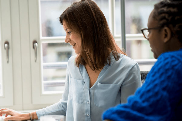 Two women collaborating in modern office