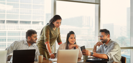 4 people looking at a computer